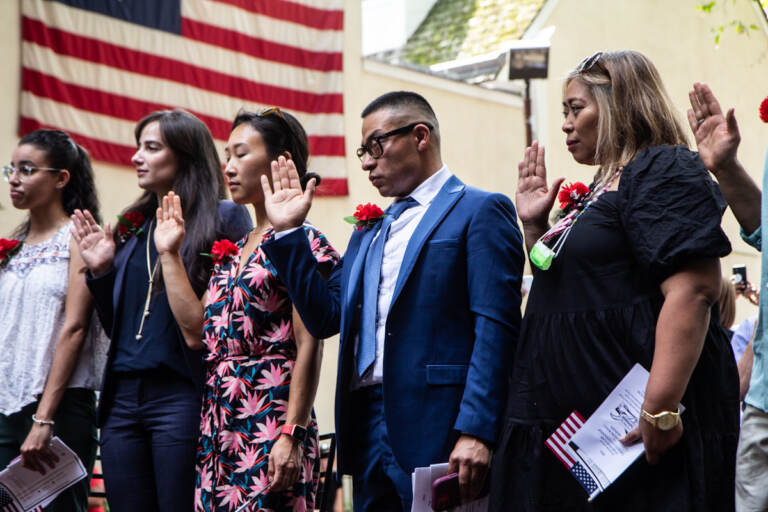 People participate in a naturalization ceremony at the Betsy Ross House