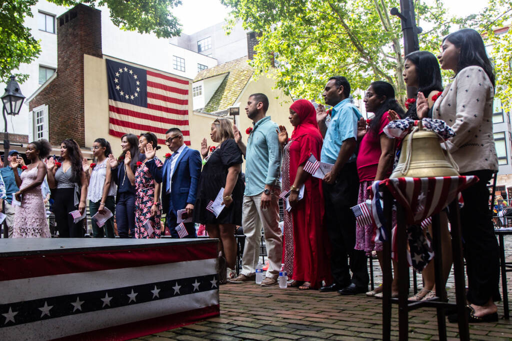 People participate in a naturalization ceremony at the Betsy Ross House