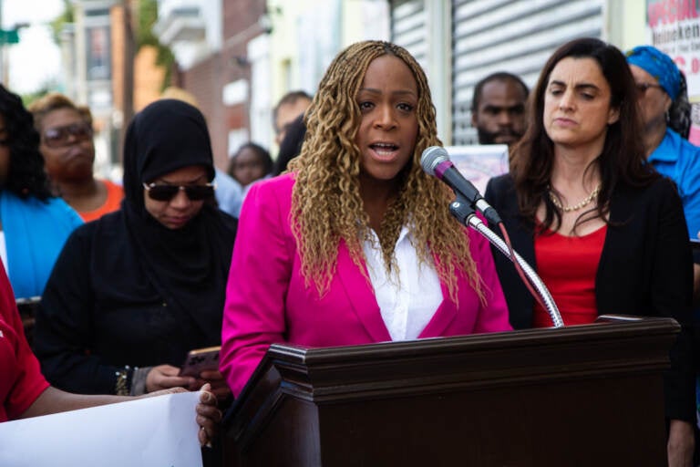 Philadelphia 3rd District Councilmember Jamie Gauthier speaks from a podium at a press conference, with elected officials behind her