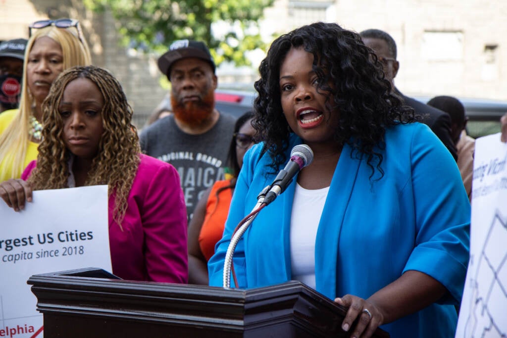 Katherine Gilmore Richardson speaks from a podium at a press conference