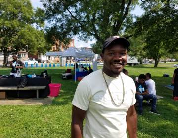 Raheem Manning stands outside at a block party