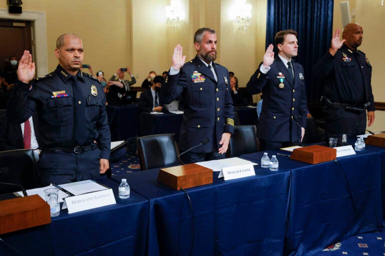 U.S. Capitol Police sergeant Aquilino Gonell; Washington DC Metropolitan Police Department officers Michael Fanone and Daniel Hodges, and U.S. Capitol Police Officer Harry Dunn are sworn in to testify during the opening hearing of the U.S. House (Select) Committee investigating the January 6 attack on the U.S. Capitol, on Capitol Hill in Washington, U.S., July 27, 2021. REUTERS/Jim Bourg/Pool