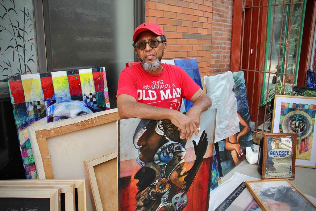 Philadelphia artist James Dupree stacks water-damaged paintings outside his galler