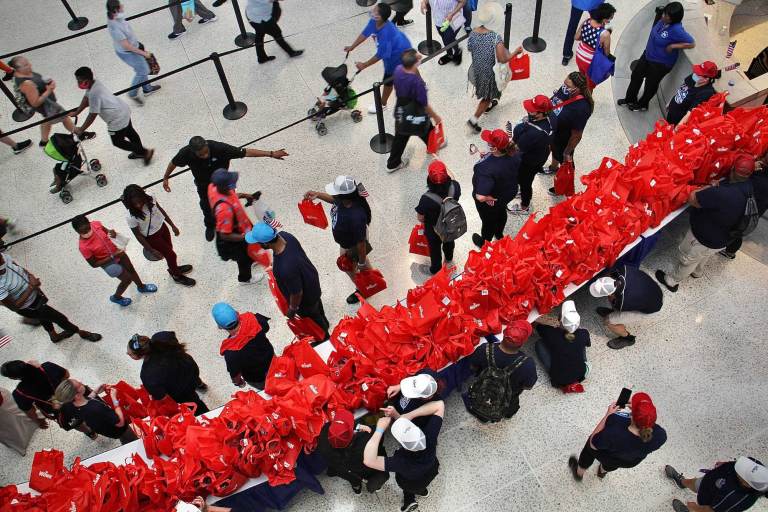 An overview shot of hundreds of red Wawa Hoagie Day swag bags on a table