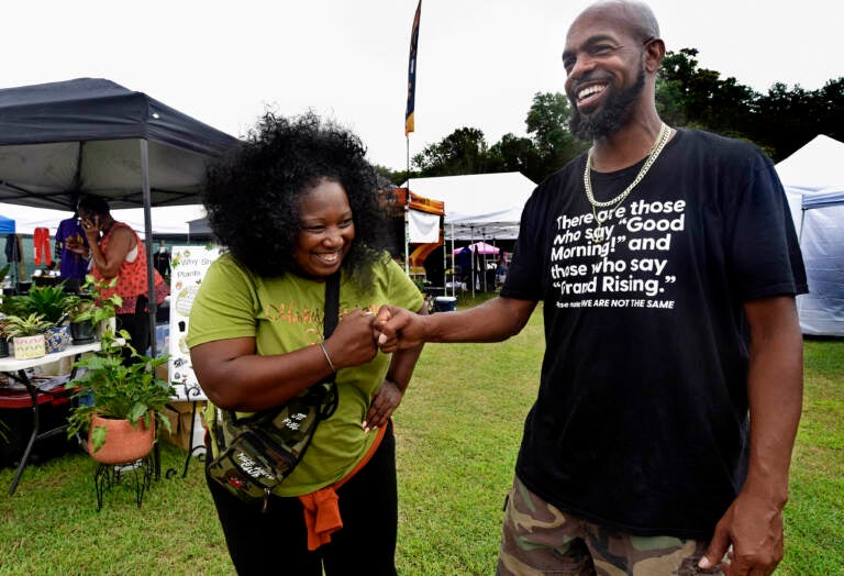 Two people pose at grand opening of Mask Melanin Market in Glassboro.