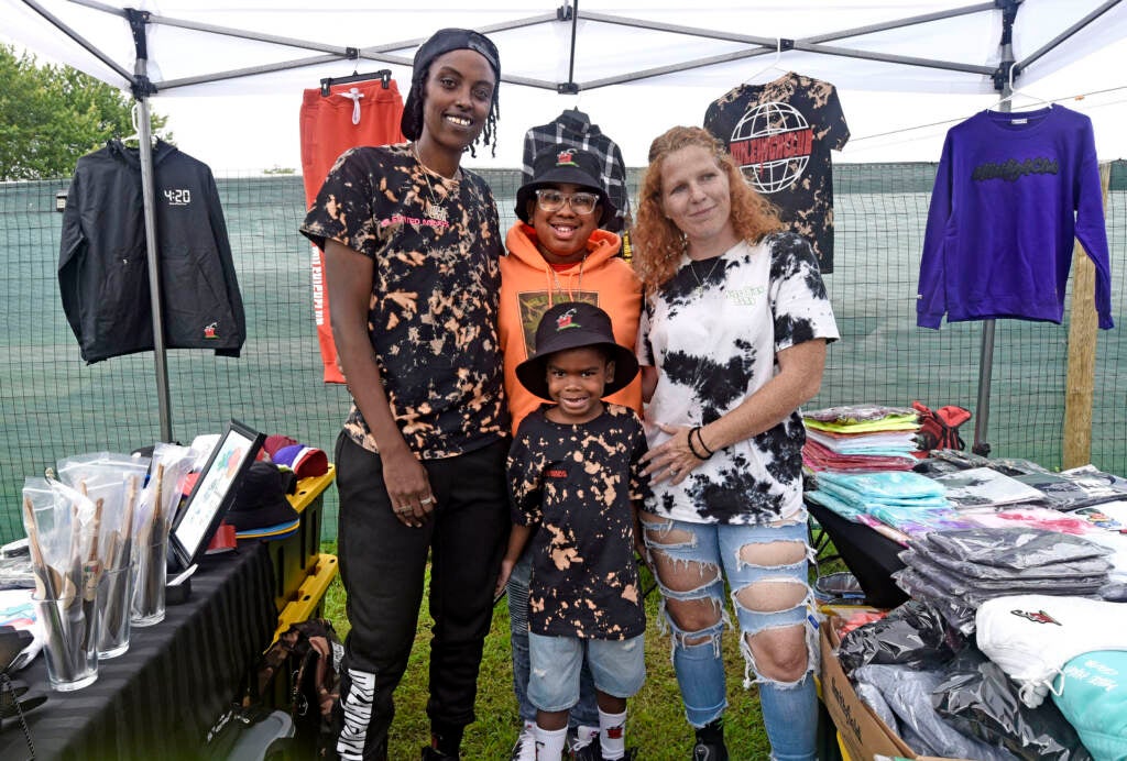 Family poses at grand opening of Mask Melanin Market.