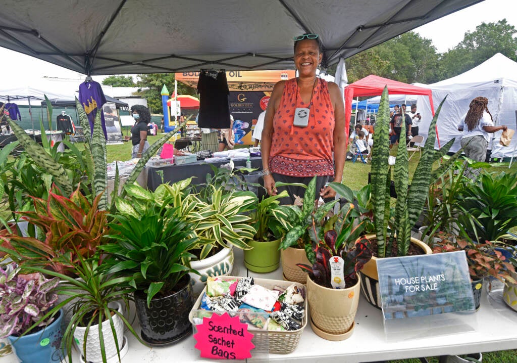 Vendor stands at booth at grand opening of Mask Melanin Market in Glassboro, NJ.