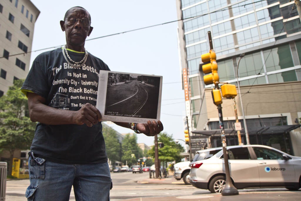 Andre Black holds a photo of Philadelphia’s Black Bottom neighborhood