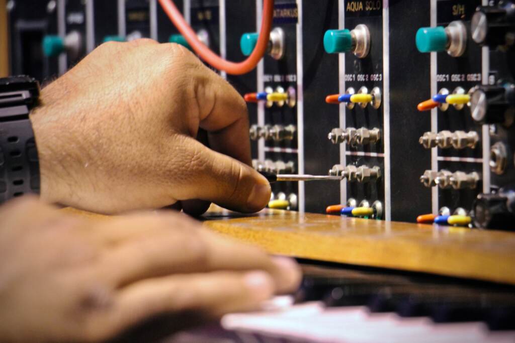 Vince Pupillo Jr. tweaks the settings on Keith Emerson's Moog synthesizer