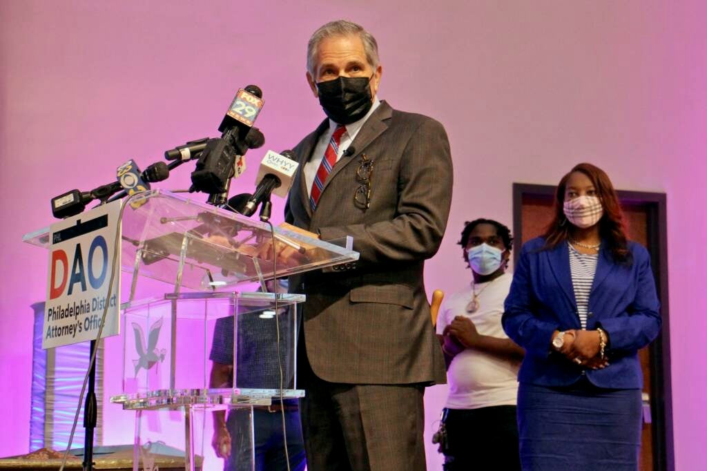 Larry Krasner, wearing a mask, speaks at a DAO press conference