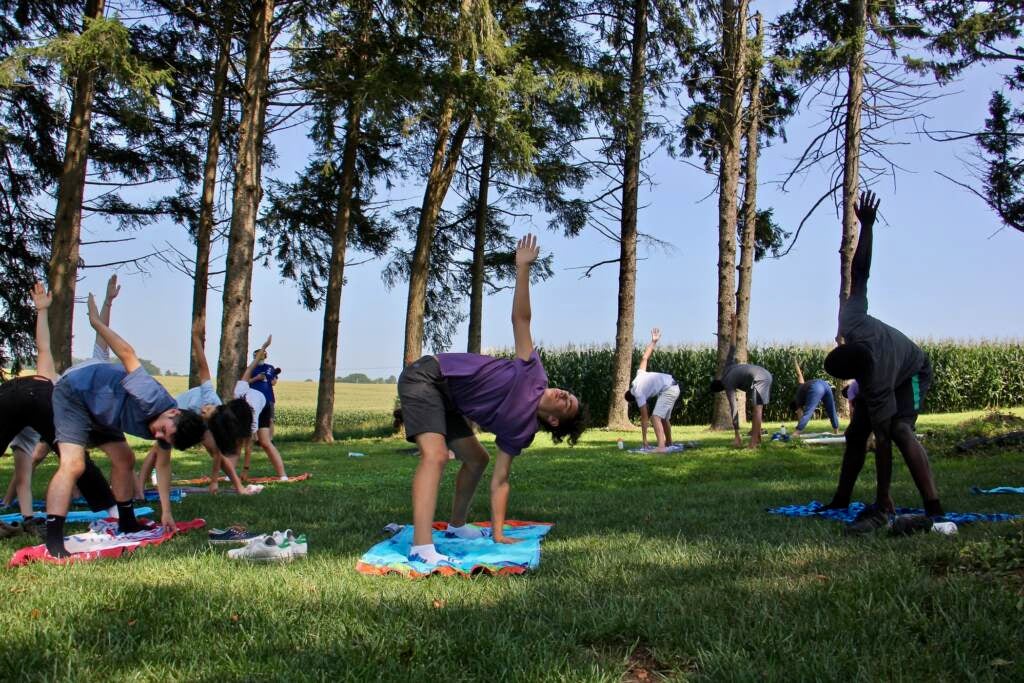 Students participate in an outdoor yoga class