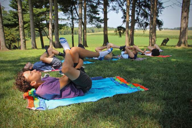 Students participate in an outdoor yoga class