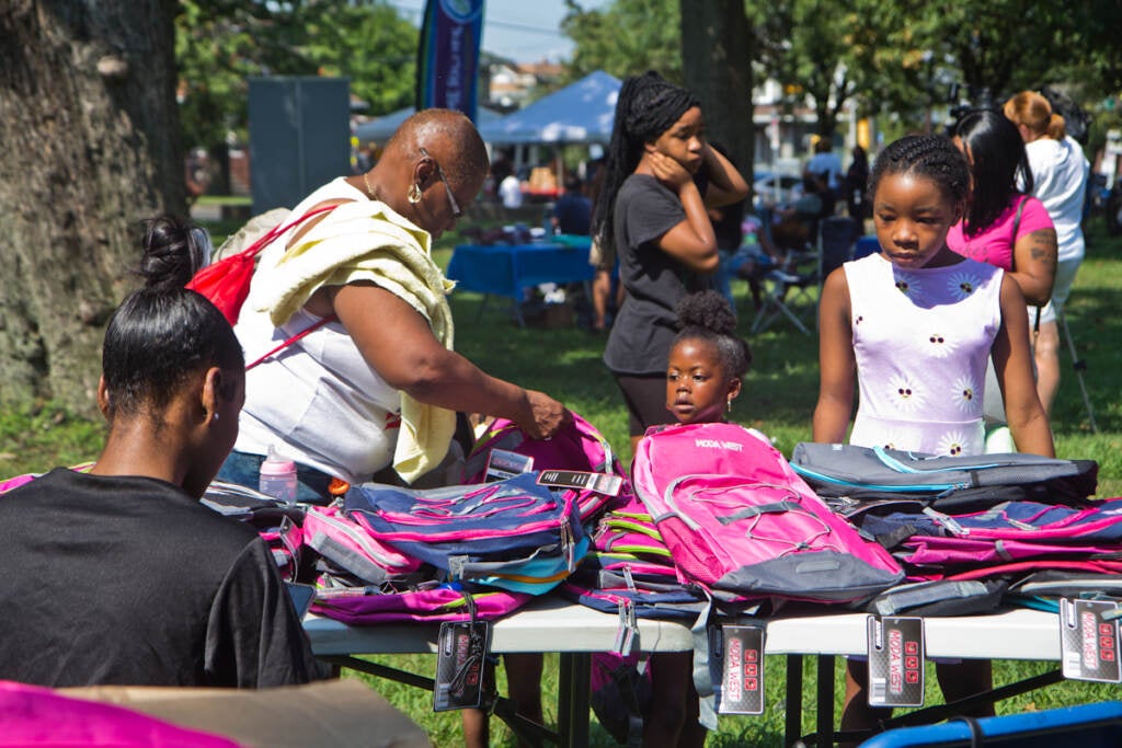 Families are given free backpacks and back-to-school supplies