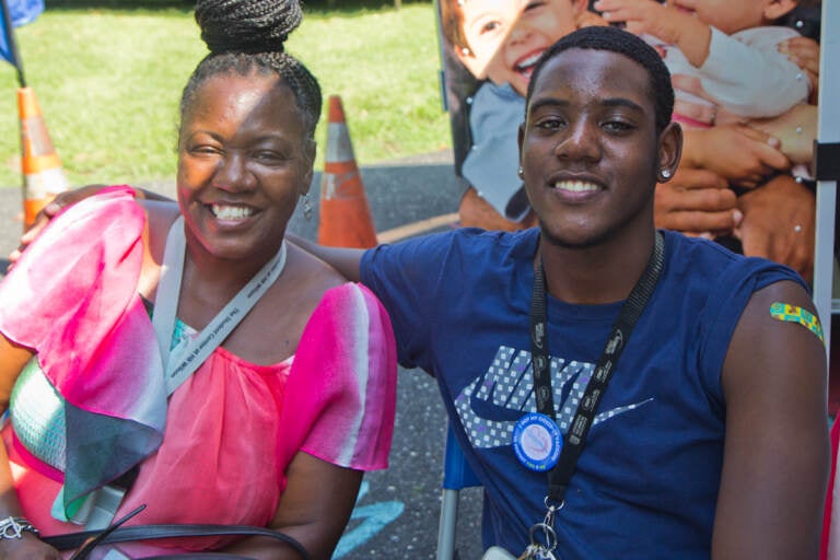 Frank Perry sits with his mom at a park