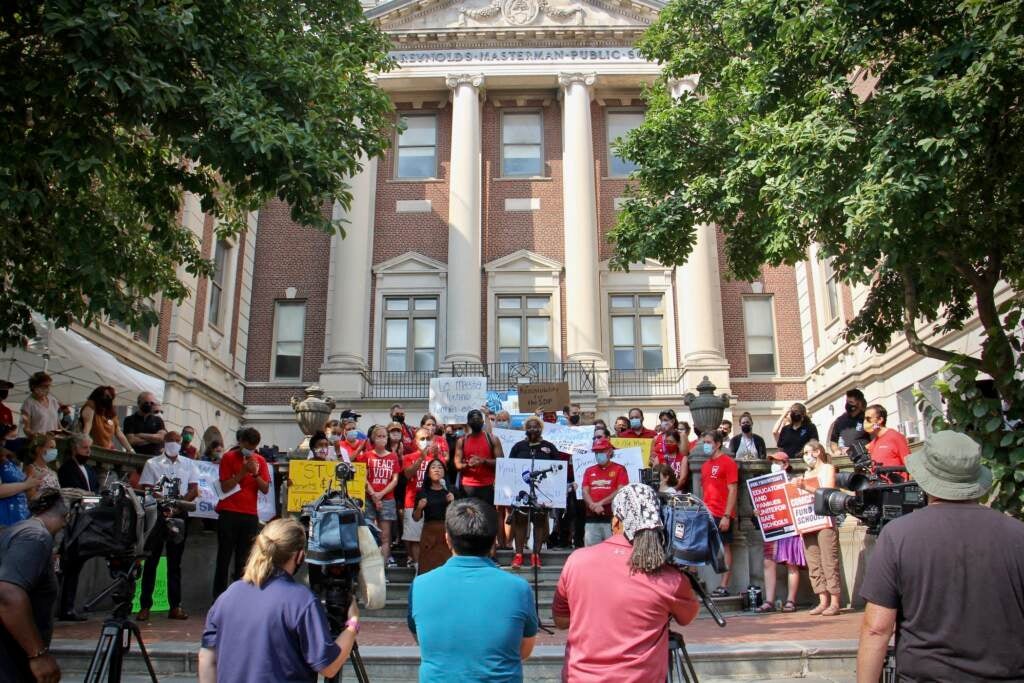 Teachers, parents and staff at the Masterman School gather on the steps of the school to voice their concerns about unsafe conditions in the building