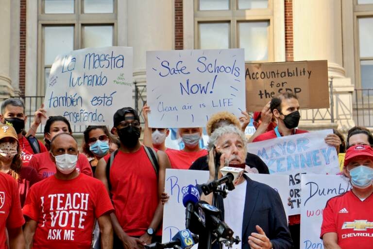 Teachers, parents and staff at the Masterman School gather on the steps of the school to voice their concerns about unsafe conditions in the building