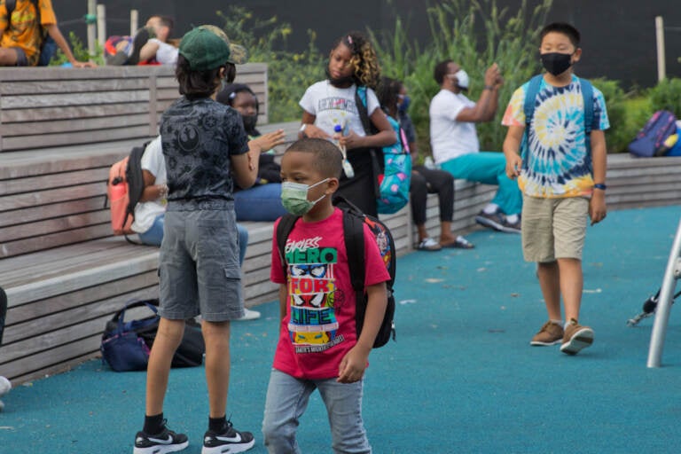 Students wear face masks outside of their school in Philly