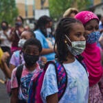 Students wear face masks outside of their school in Philly