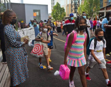 Students wear face masks outside of their school in Philly