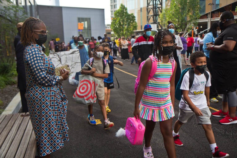 Students wear face masks outside of their school in Philly