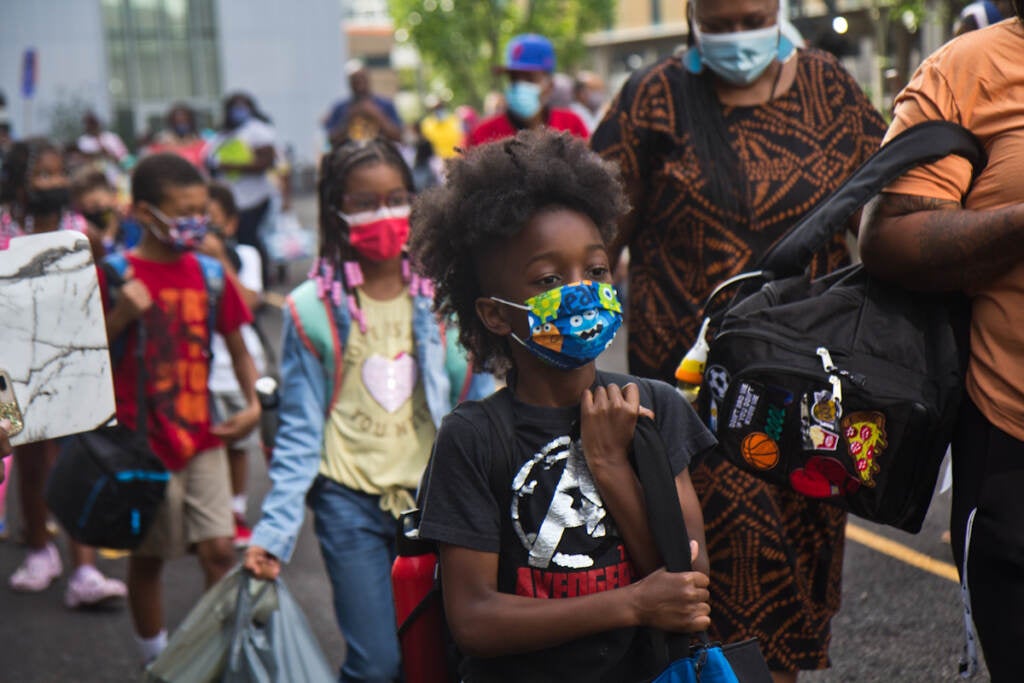 Students wear face masks outside of their school in Philly