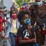 Students wear face masks outside of their school in Philly