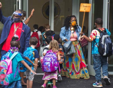 Students wear face masks outside of their school in Philly