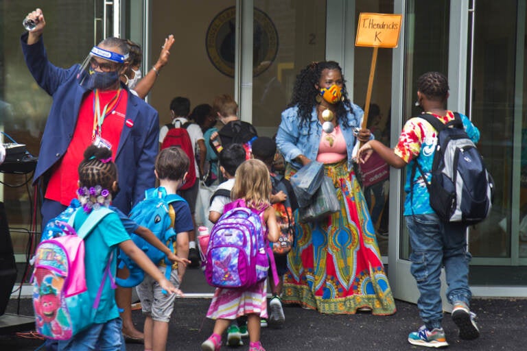 Students wear face masks outside of their school in Philly