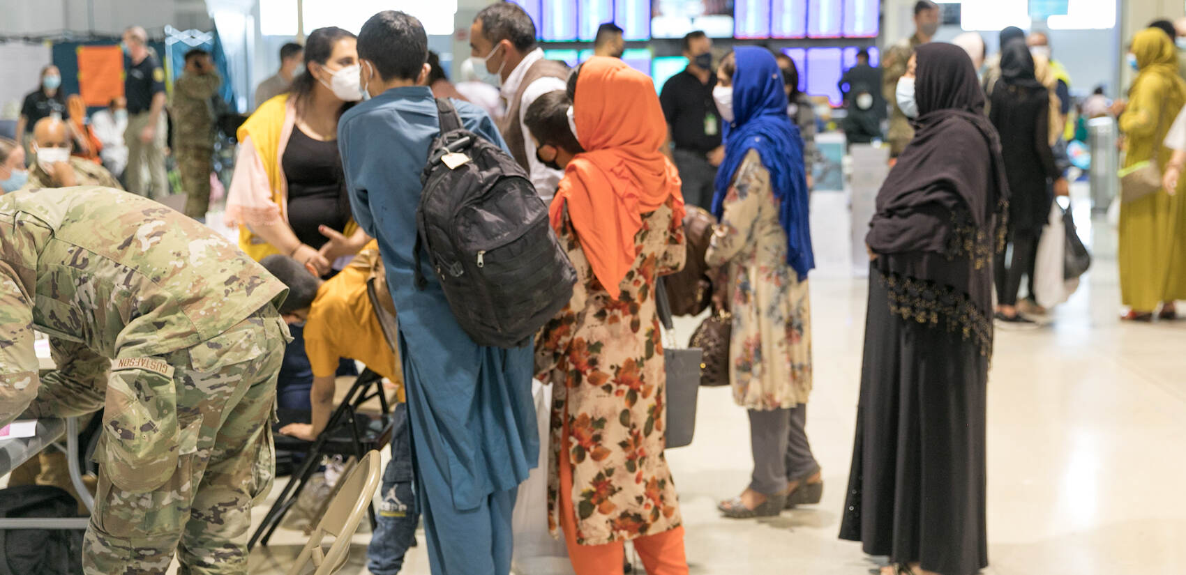 Evacuees stand inside Philadelphia International Airport