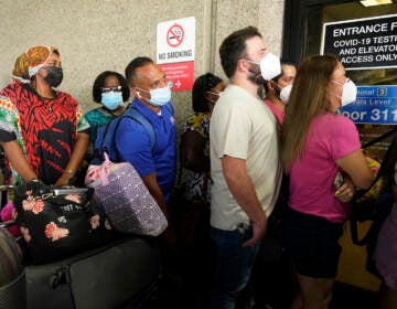 Passengers wait in a long line to get a COVID-19 test to travel overseas at Fort Lauderdale-Hollywood International Airport, Friday, Aug. 6, 2021, in Fort Lauderdale, Fla. Recent flight cancelations caused many passengers to redo their tests while others were unable to get the test locally due to long lines caused by the surge of the Delta variant. (AP Photo/Marta Lavandier)