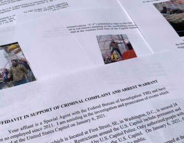 The affidavit from the FBI in support of an arrest warrant for Scott Kevin Fairlamb is photographed on Aug. 6, 2021. The New Jersey gym owner has become the first person to plead guilty to assaulting a law enforcement officer during the Jan. 6 riot at the U.S. Capitol. Federal prosecutors say Fairlamb was one of the very first rioters to breach the Capitol. (AP Photo/Jon Elswick)