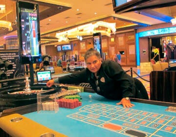 This June 28, 2021 photo shows a dealer at the Hard Rock casino in Atlantic City NJ conducting a game of roulette. Figures released Aug. 10, 2021 by the American Gaming Association show the nation's commercial casinos had their best second quarter in history, with $13.6 billion in revenue, and are on pace to have their best year ever in 2021 as gamblers return to in-person casinos. (AP Photo/Wayne Parry)