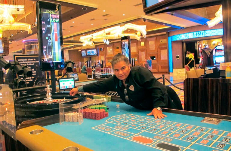 This June 28, 2021 photo shows a dealer at the Hard Rock casino in Atlantic City NJ conducting a game of roulette. Figures released Aug. 10, 2021 by the American Gaming Association show the nation's commercial casinos had their best second quarter in history, with $13.6 billion in revenue, and are on pace to have their best year ever in 2021 as gamblers return to in-person casinos. (AP Photo/Wayne Parry)