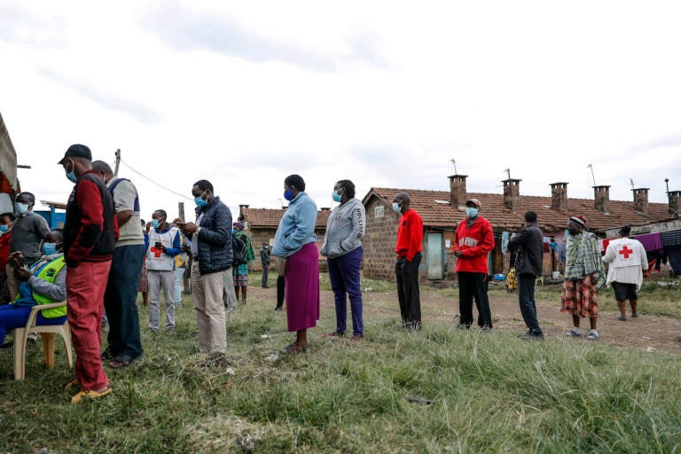 Kenyans queue to receive AstraZeneca coronavirus vaccine donated by Britain, at the Makongeni Estate in Nairobi, Kenya Saturday, Aug. 14, 2021. An international system to share coronavirus vaccines was supposed to guarantee that low and middle-income countries could get doses without being last in line and at the mercy of unreliable donations but it hasn't worked out that way and in late June alone, the initiative known as COVAX sent some 530,000 doses to Britain – more than double the amount sent that month to the entire continent of Africa. (AP Photo/Brian Inganga)