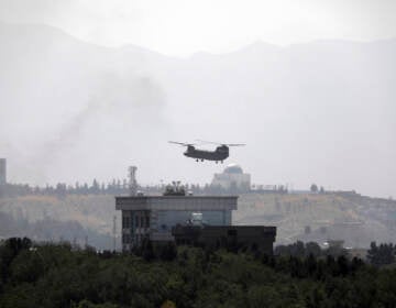 A U.S.Chinook helicopter flies over the U.S. Embassy, in Kabul, Afghanistan, Sunday, Aug. 15, 2021. Helicopters are landing at the U.S. Embassy in Kabul as diplomatic vehicles leave the compound amid the Taliban advanced on the Afghan capital. (AP Photo/Rahmat Gul)