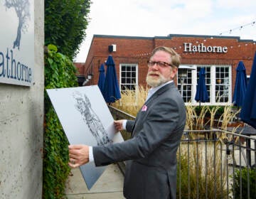 Hathorne restaurant owner John Stephenson holds a sign for a pop-up restaurant which will cover the Hathorne sign when that restaurant is open, Wednesday, Aug. 18, 2021, in Nashville, Tenn. Stephenson hosts temporary restaurants, known as pop-ups which he lets use his space, in an effort to help them weather the pandemic. Most recently, Hathorne hosts the pop-up St. Vito Focacciaria pizza company, which sign he holds, every Sunday night. (AP Photo/John Amis)