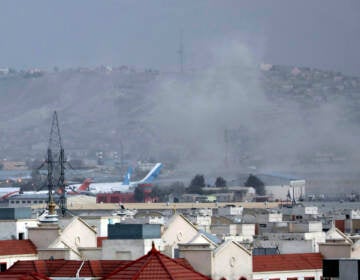 Smoke rises from a deadly explosion outside the airport in Kabul, Afghanistan, Thursday, Aug. 26, 2021. Two suicide bombers and gunmen have targeted crowds massing near the Kabul airport, in the waning days of a massive airlift that has drawn thousands of people seeking to flee the Taliban takeover of Afghanistan. (AP Photo/Wali Sabawoon)