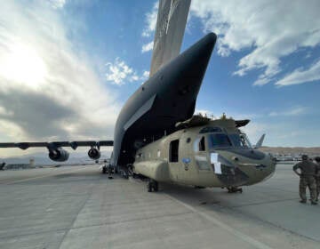 In this image provided by the Department of Defense, a CH-47 Chinook from the 82nd Combat Aviation Brigade, 82nd Airborne Division is loaded onto a U.S. Air Force C-17 Globemaster III at Hamid Karzai International Airport in Kabul, Afghanistan, Saturday, Aug, 28, 2021. (Department of Defense via AP)