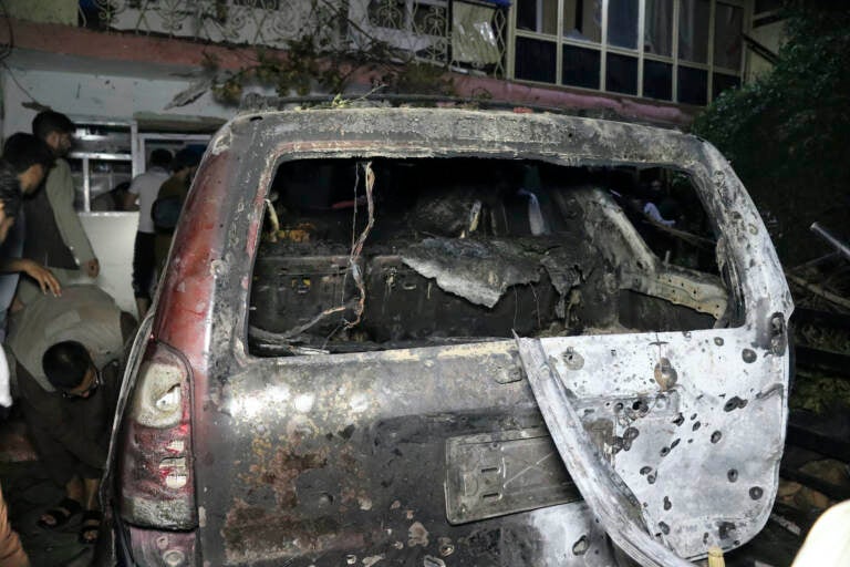A destroyed vehicle is seen inside a house after a U.S. drone strike
