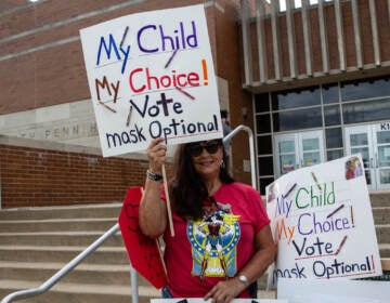 A North Penn parent wishing to only be identified as 'mom', protested mask mandates outside the school board meeting on August 19, 2021. (Kimberly Paynter/WHYY)