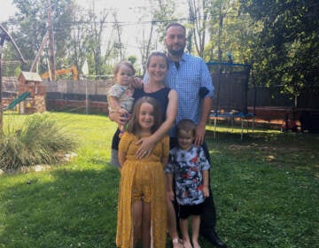 Megan and Bob White with their three kids in their Chester County backyard. Work on the Mariner East 2 pipeline has turned half the property into a construction site, and the project has been plagued by sinkholes and schedule overruns. (Katie Meyer/WHYY)
