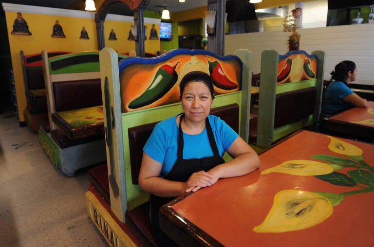 Maudy Mendez, owner of Maudy's Hispanic Cuisine located on East Market Street in Georgetown, takes a brief break from cooking on Wednesday.    (Butch Comegys/Delaware State News)