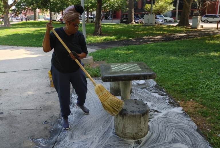 Rashonda Pinson cleans a portion of the park