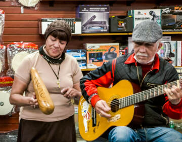 A woman and man playing music at Centro Musical