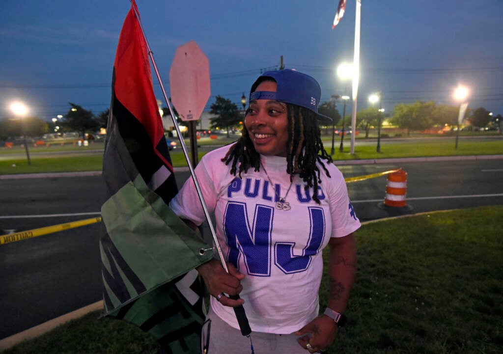 Lashay Alston holds a Black Lives Matter flag