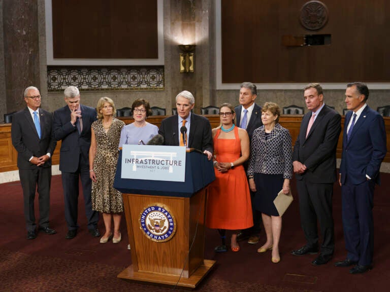 The bipartisan group of senators who are behind the infrastructure package talk to the press on July 28. (J. Scott Applewhite/AP)