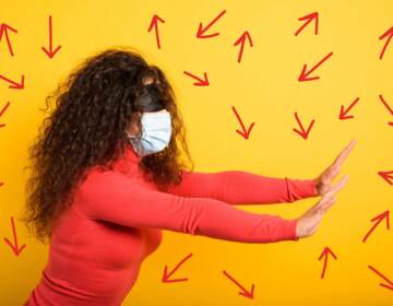 Woman with mask and blindfold has her arms out trying to find her way, expressing uncertainty