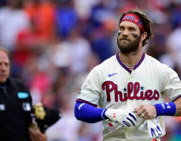 Bryce Harper stands by home plate.