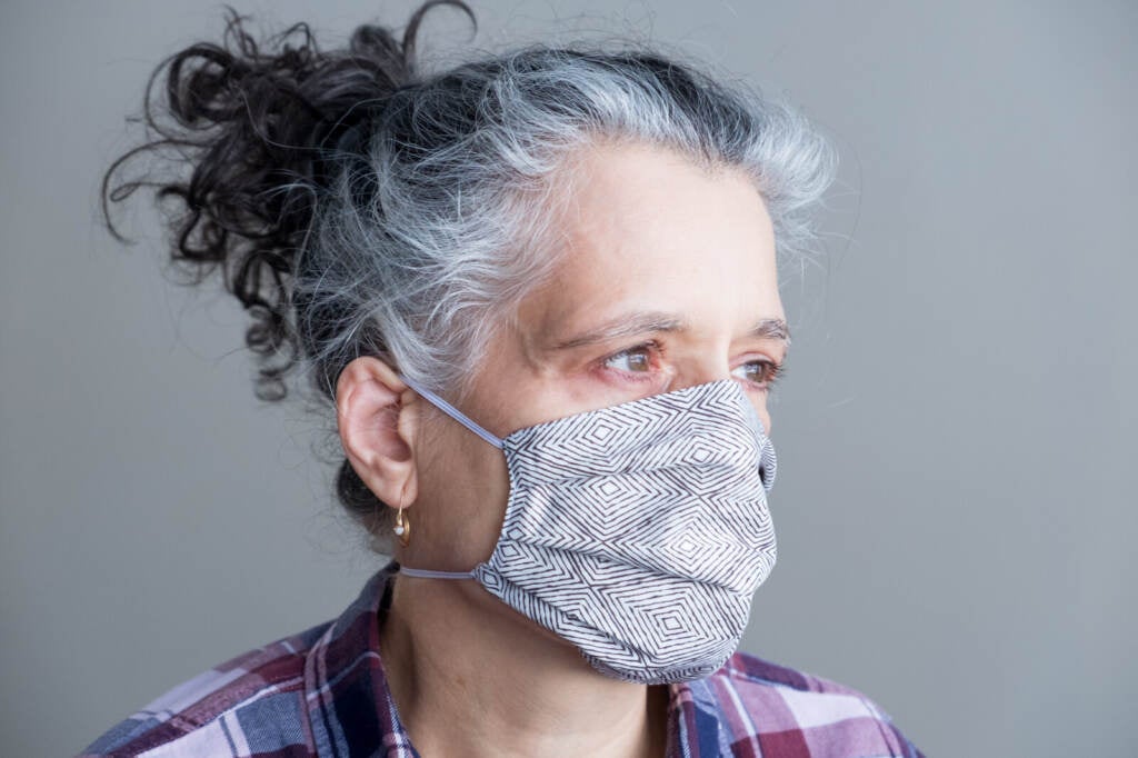 A woman wears a cloth mask