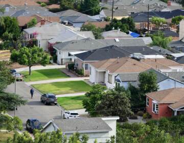 A man walks through a neighborhood of single-family homes in Los Angeles last week. The CDC announced a new temporary eviction ban a few days after the previous one expired. (Frederic J. Brown/AFP via Getty Images)